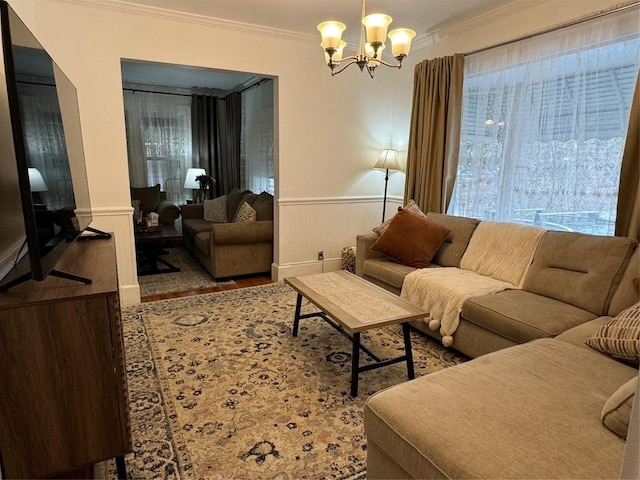 living room with a notable chandelier and crown molding