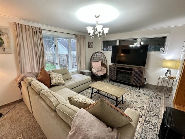 carpeted living room featuring a notable chandelier