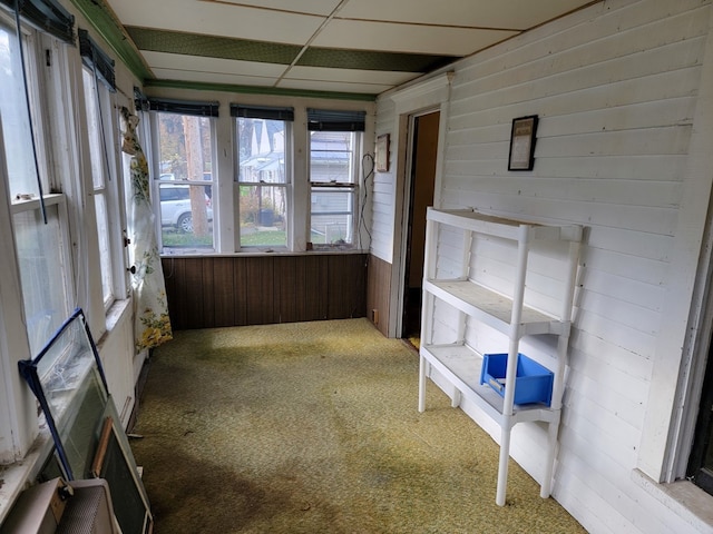 unfurnished sunroom featuring a paneled ceiling