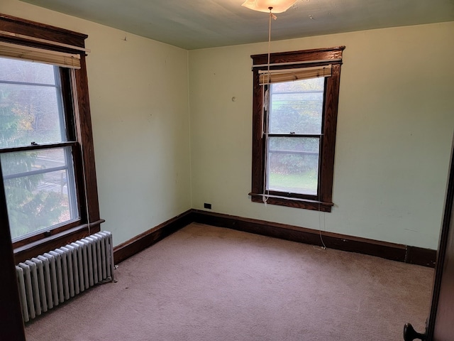 carpeted empty room with radiator