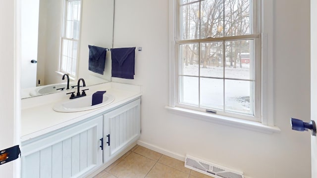 bathroom featuring tile patterned flooring, vanity, and a healthy amount of sunlight