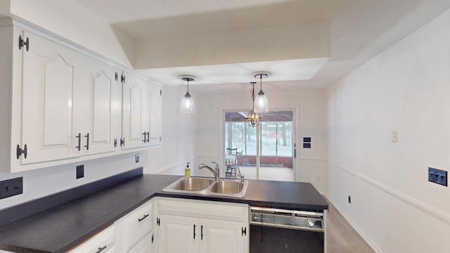 kitchen with kitchen peninsula, sink, white cabinets, black dishwasher, and hanging light fixtures