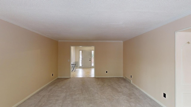 carpeted spare room featuring crown molding and a textured ceiling