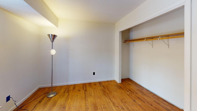 unfurnished bedroom featuring a closet and wood-type flooring