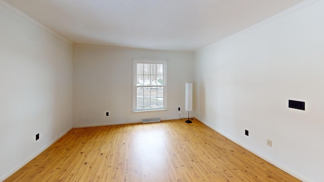 empty room with light wood-type flooring and ornamental molding