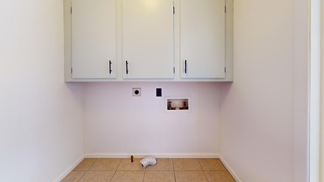 laundry room with hookup for an electric dryer, cabinets, light tile patterned floors, and washer hookup