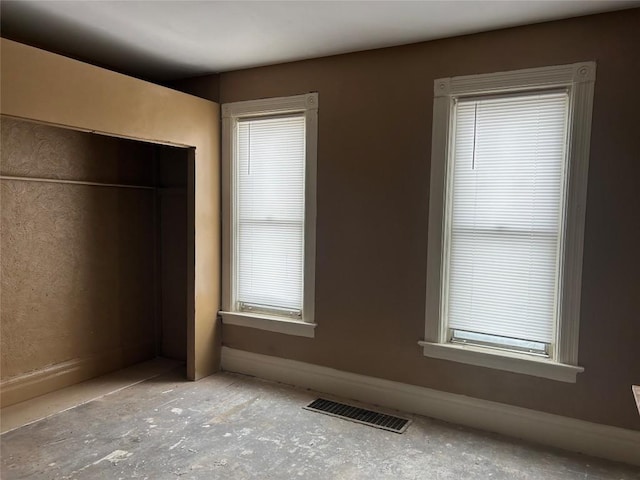 unfurnished bedroom with baseboards and visible vents