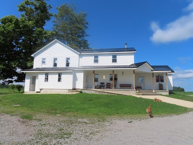 view of front of home featuring covered porch and a front yard