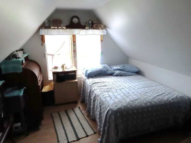 bedroom with lofted ceiling