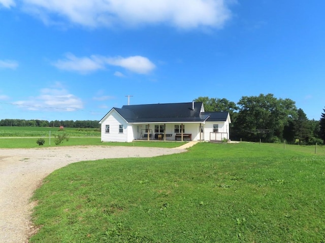 back of property with a porch and a yard