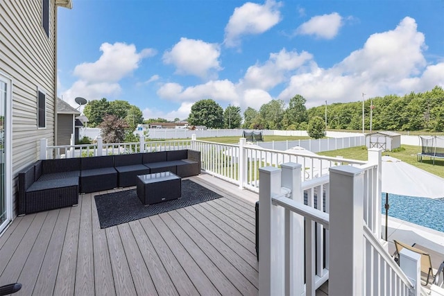 7662 Magnolia Bnd, Fairview, PA 16415 - wooden deck featuring outdoor lounge area and a trampoline