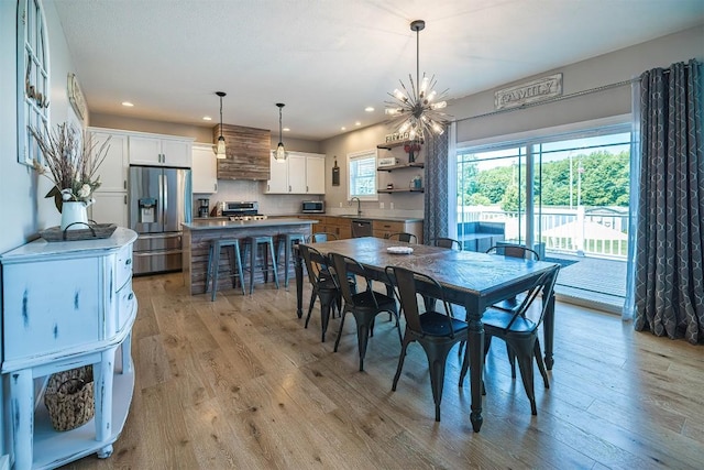 7662 Magnolia Bnd, Fairview, PA 16415 - dining room with light wood-type flooring, recessed lighting, and a chandelier