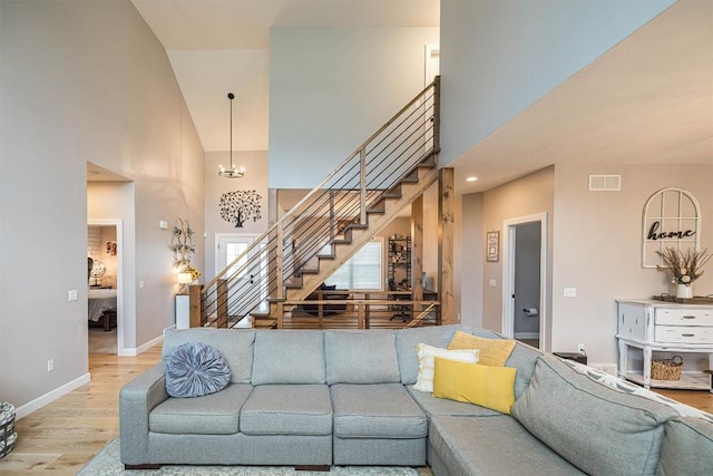7662 Magnolia Bnd, Fairview, PA 16415 - living room featuring light wood finished floors, high vaulted ceiling, and stairs