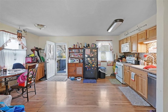 221 Pheasant Dr, Girard, PA 16417 - kitchen featuring light countertops, light wood-style floors, a sink, and white appliances