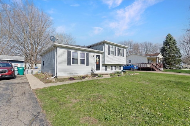 221 Pheasant Dr, Girard, PA 16417 - tri-level home with a front lawn, aphalt driveway, and a deck