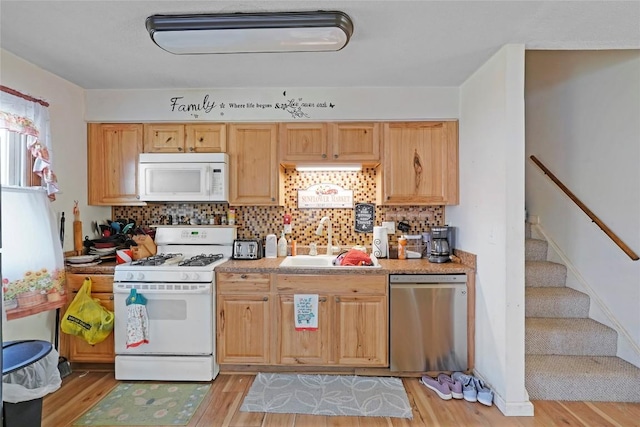221 Pheasant Dr, Girard, PA 16417 - kitchen featuring light wood finished floors, light countertops, a sink, white appliances, and decorative backsplash