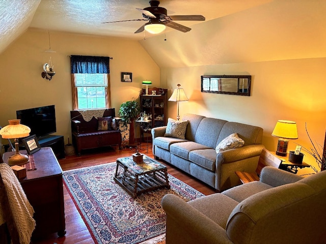 living room featuring a textured ceiling, a ceiling fan, wood finished floors, and lofted ceiling