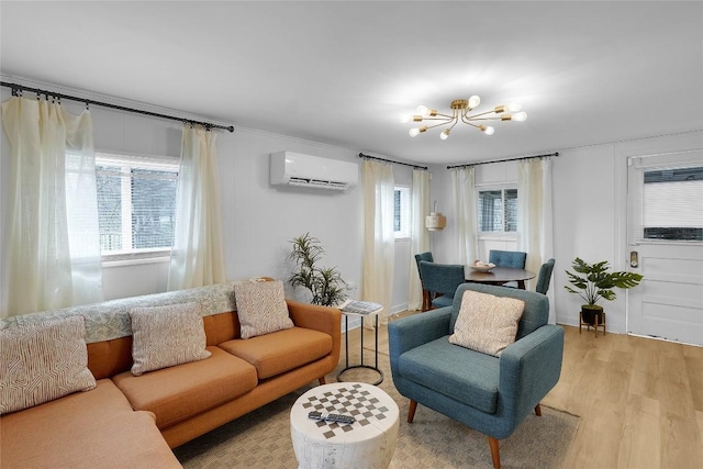 living area with a wall mounted air conditioner, light wood-style floors, and a notable chandelier