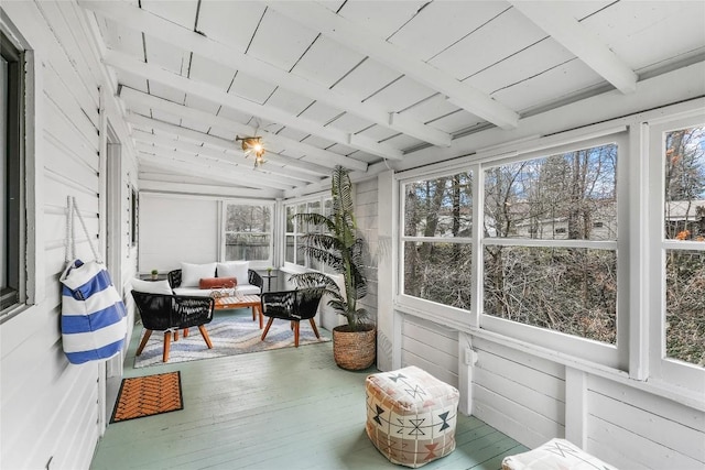 sunroom featuring beam ceiling