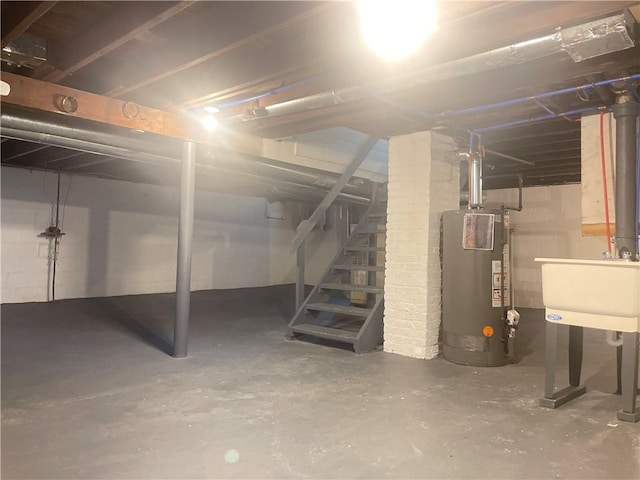 basement featuring water heater and sink