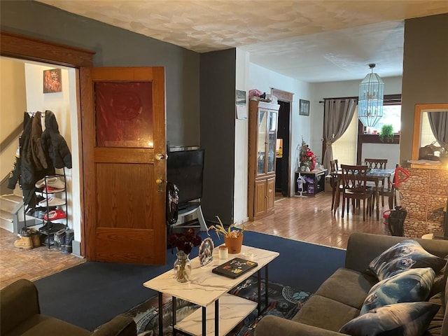 living room featuring an inviting chandelier and hardwood / wood-style floors