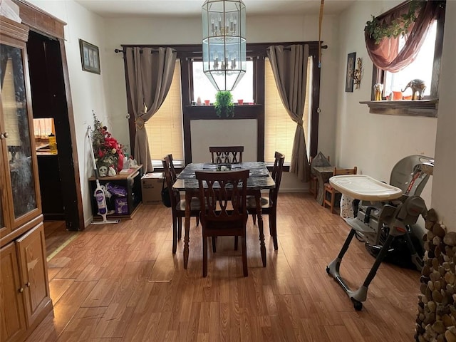 dining room with hardwood / wood-style flooring and a chandelier