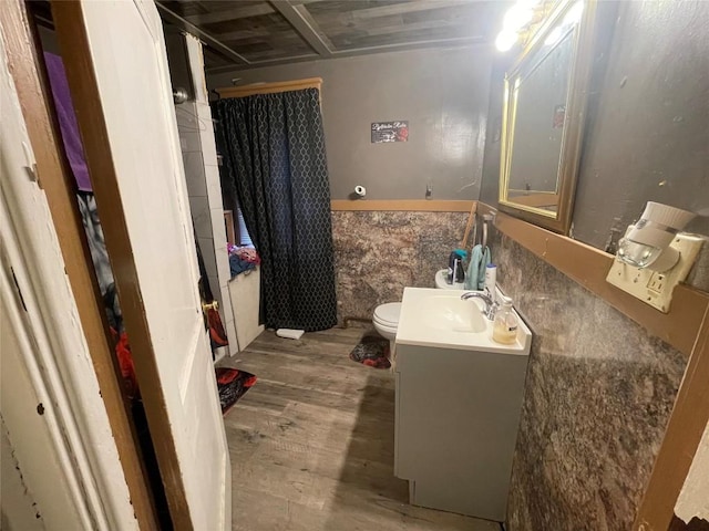 bathroom with vanity, toilet, and hardwood / wood-style floors