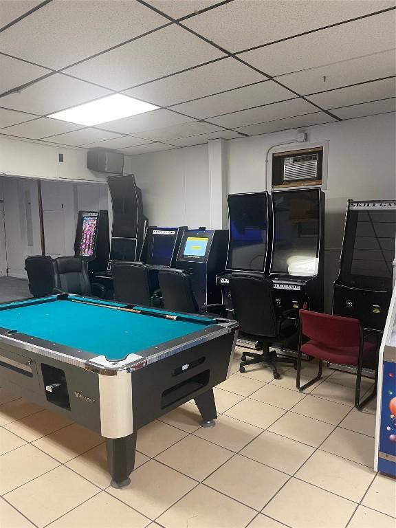 rec room featuring light tile patterned flooring, a paneled ceiling, and pool table