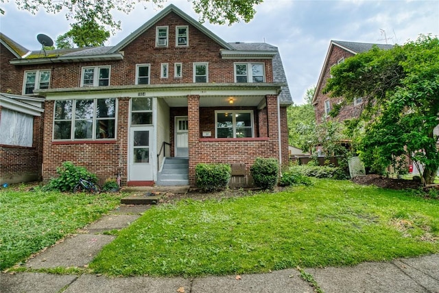 1032 Newton Ave, Erie, PA 16511 - townhome / multi-family property with a front lawn, brick siding, and a porch