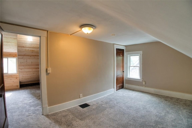 1032 Newton Ave, Erie, PA 16511 - additional living space with carpet flooring, vaulted ceiling, and wooden walls