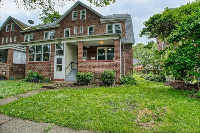 1032 Newton Ave, Erie, PA 16511 - view of front of house featuring brick siding, a front yard, and a shingled roof
