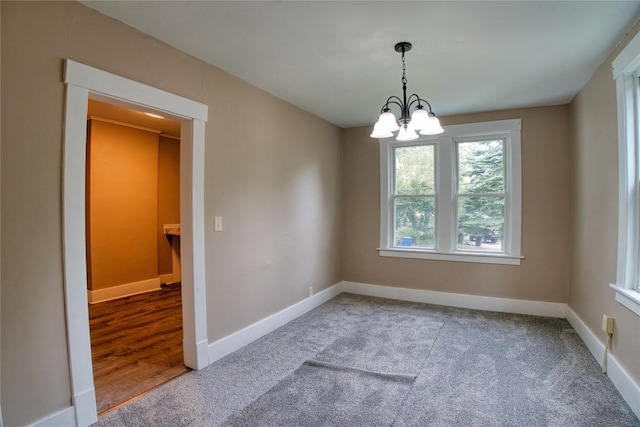 1032 Newton Ave, Erie, PA 16511 - spare room with a chandelier and carpet floors