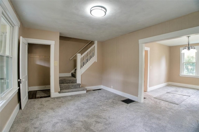 1032 Newton Ave, Erie, PA 16511 - unfurnished room featuring carpet, stairs, and a chandelier