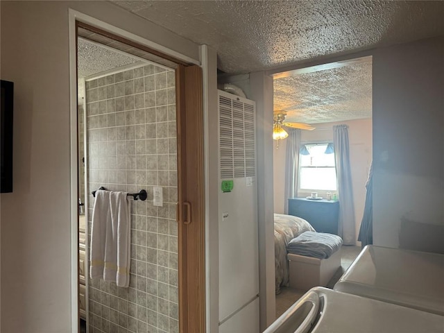 bathroom featuring a heating unit, a textured ceiling, and a ceiling fan