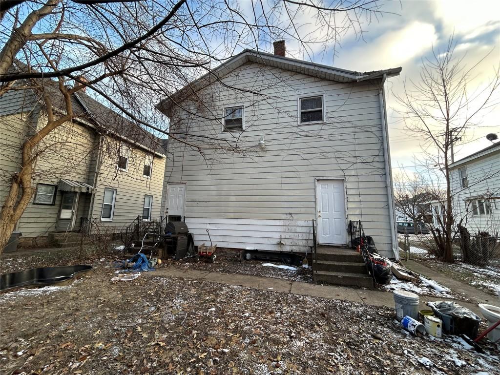 view of snow covered back of property