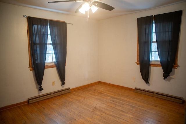 unfurnished room featuring hardwood / wood-style flooring, a baseboard radiator, and ceiling fan