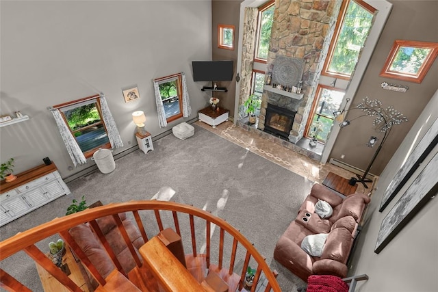 11221 W Greene Rd, Waterford, PA 16441 - living area featuring a fireplace, baseboards, carpet flooring, and a towering ceiling