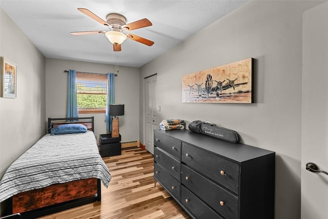11221 W Greene Rd, Waterford, PA 16441 - bedroom featuring light wood-type flooring, ceiling fan, baseboard heating, and a closet