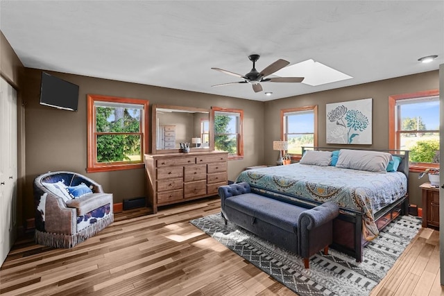 11221 W Greene Rd, Waterford, PA 16441 - bedroom featuring a skylight, multiple windows, wood finished floors, and a ceiling fan