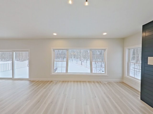 unfurnished living room with plenty of natural light and light wood-type flooring