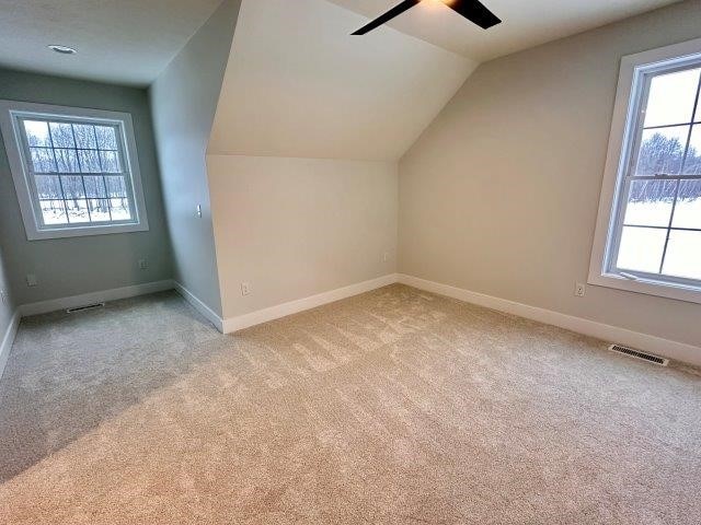 bonus room featuring light carpet, ceiling fan, and lofted ceiling