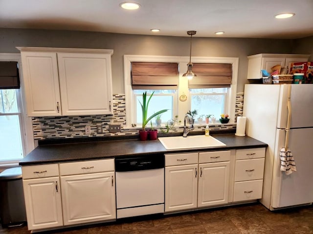 kitchen with white appliances, tasteful backsplash, white cabinetry, and sink