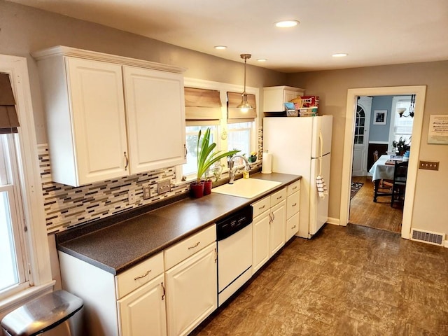 kitchen with white appliances, backsplash, sink, decorative light fixtures, and white cabinetry