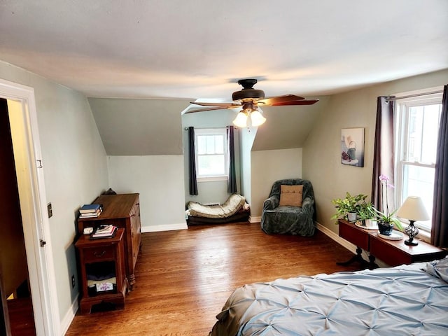 bedroom featuring multiple windows, ceiling fan, vaulted ceiling, and hardwood / wood-style flooring