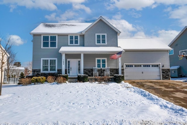 view of front of property with a garage and covered porch