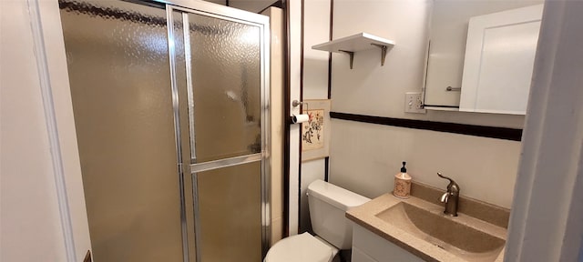 bathroom featuring vanity, toilet, and walk in shower