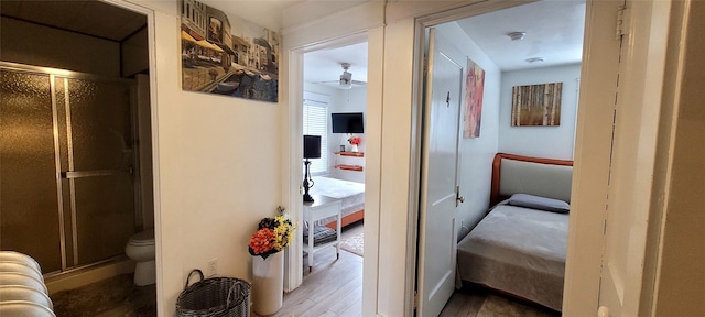 corridor with hardwood / wood-style flooring