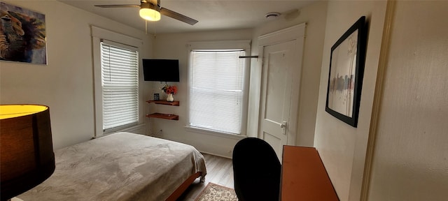 bedroom with ceiling fan and light hardwood / wood-style flooring