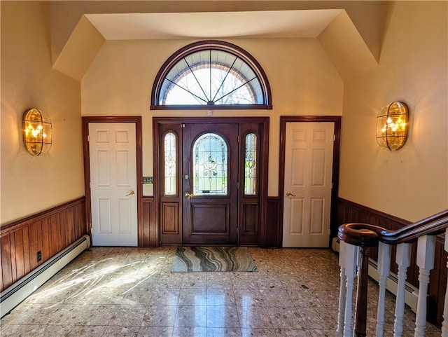 entrance foyer with high vaulted ceiling and a baseboard heating unit