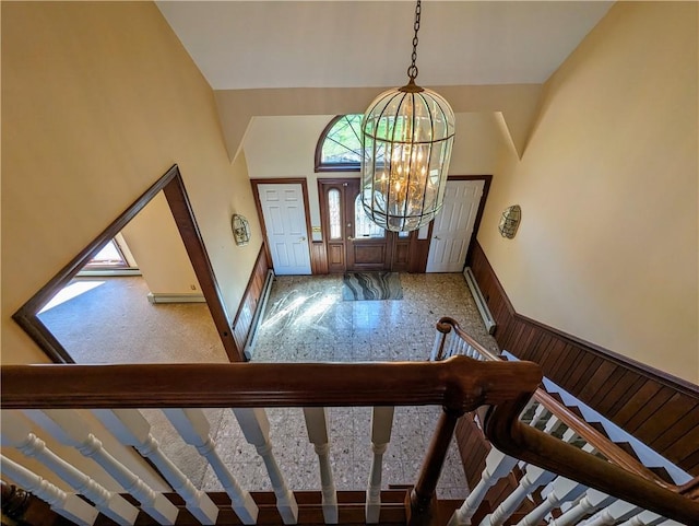 entryway with a high ceiling and a notable chandelier